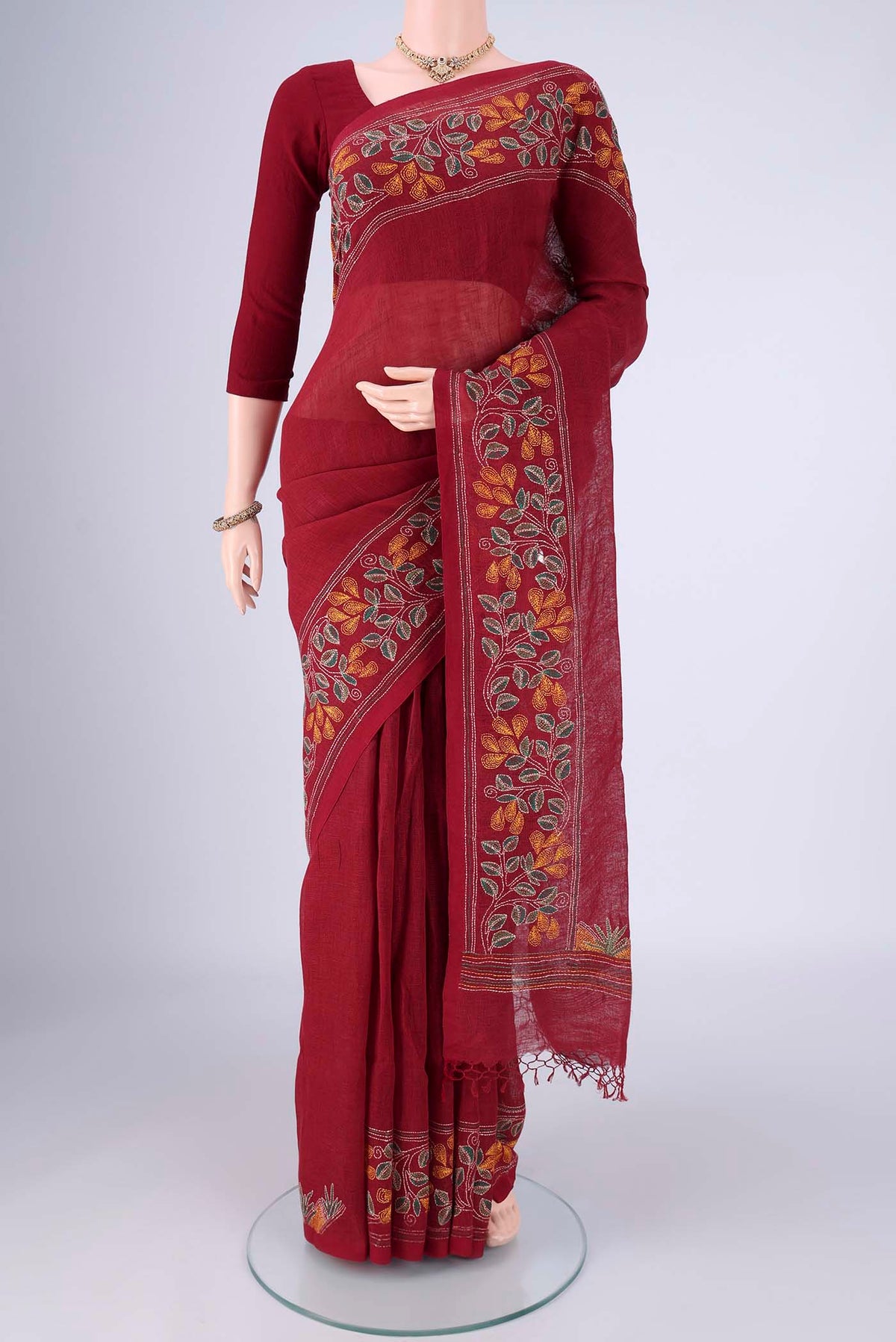 Maroon Linen Cotton Saree with Kantha Work on the body and Thread Border.  displayed on a mannequin