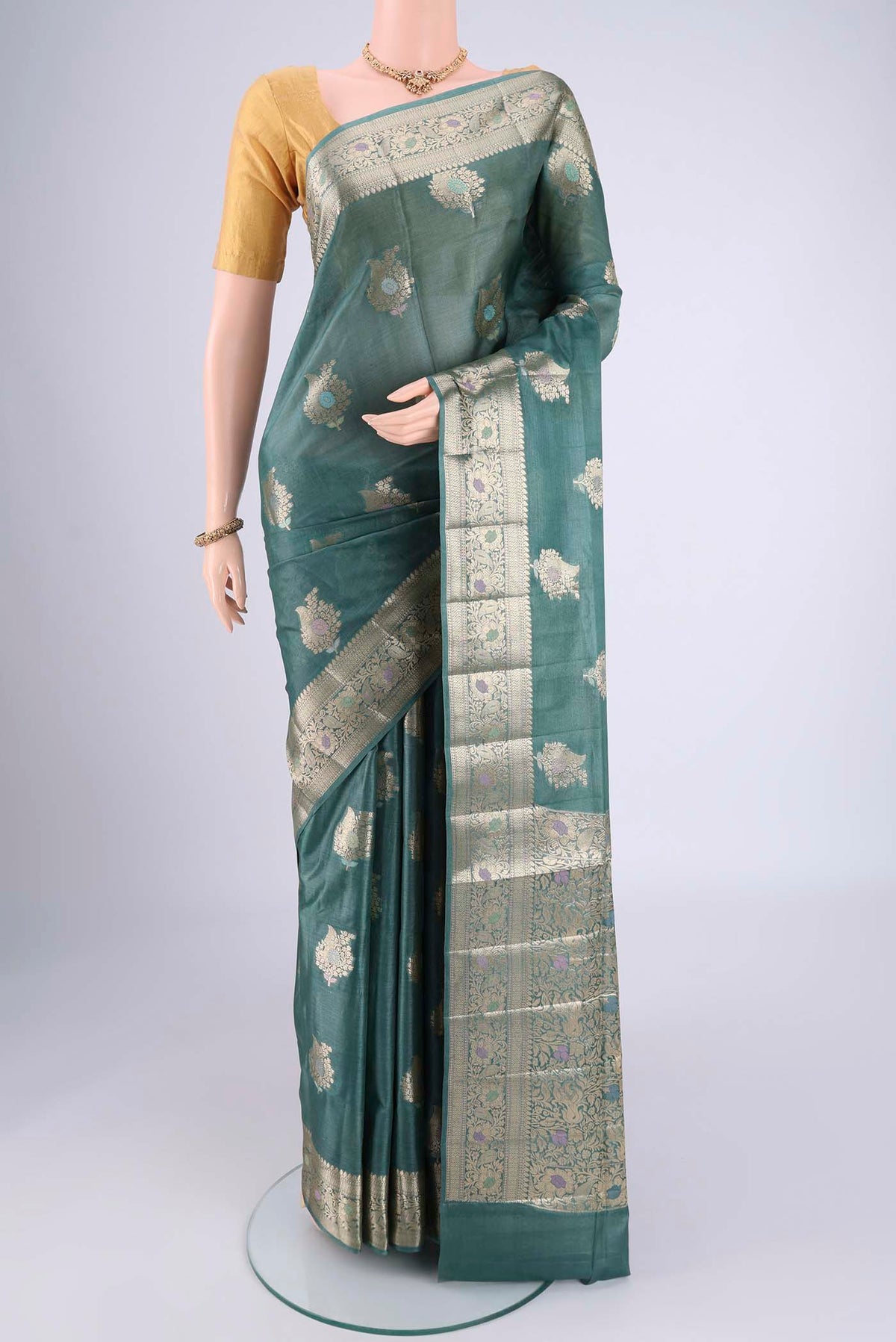 Maya Blue Banarasi Tussar Silk Saree with Zari And Thread Butta on the body and Zari And Thread Border.  displayed on a mannequin