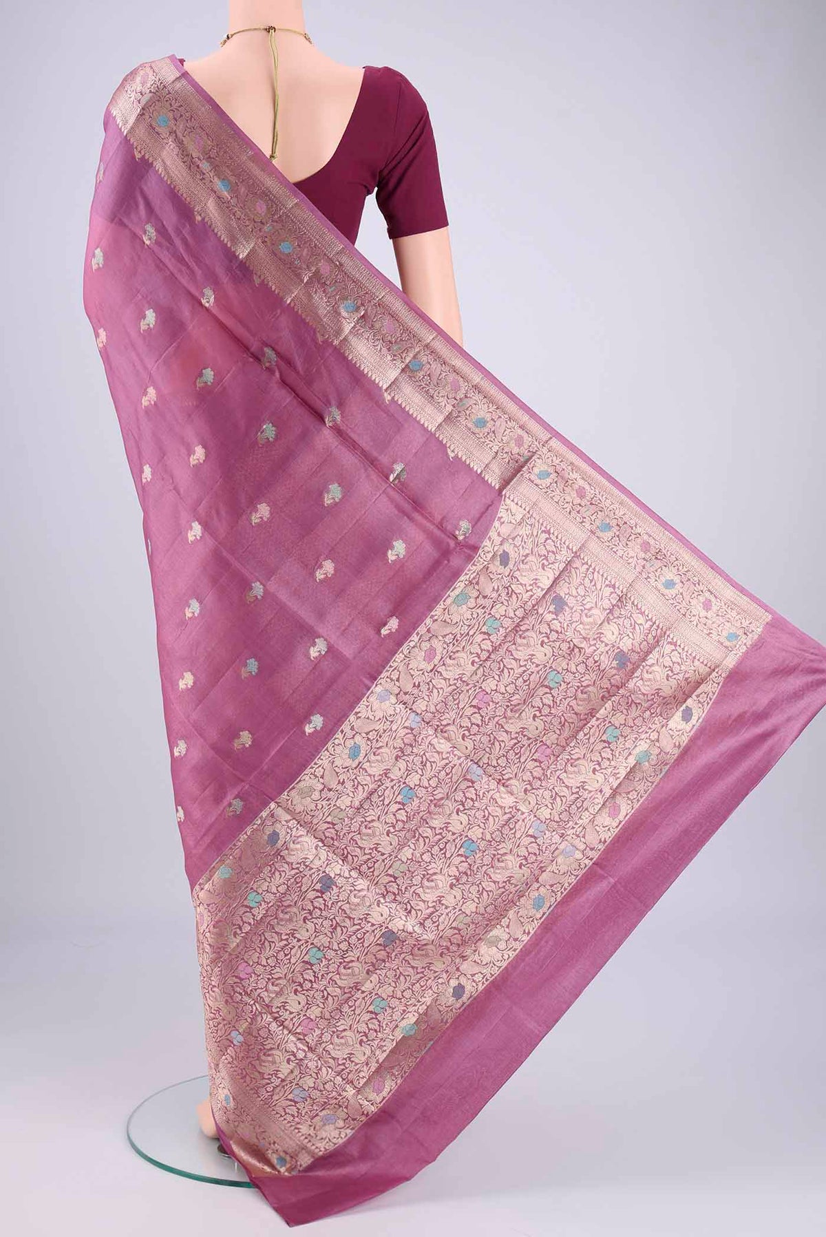Flat view of Light Magenta Banarasi Tussar Silk Saree with Zari And Thread Butta on the body and Zari And Thread Border. 