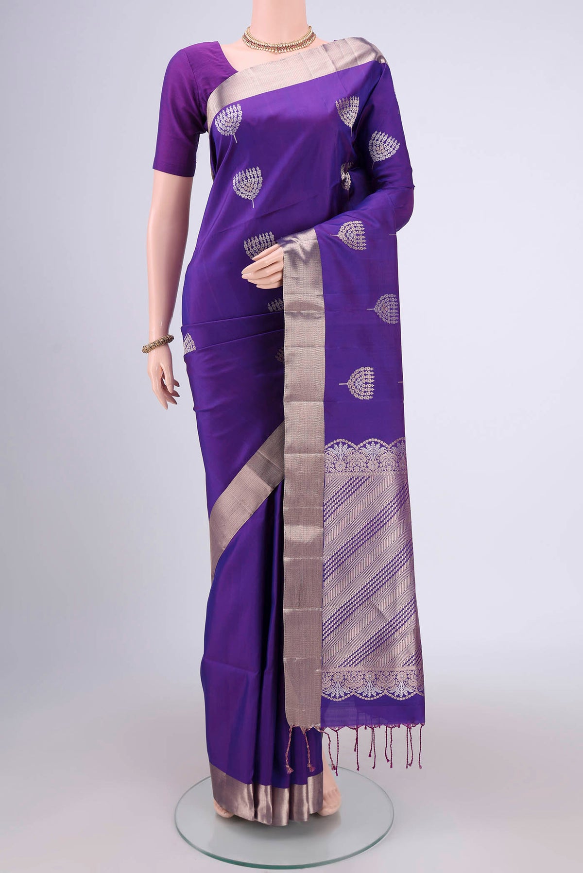 Violet Soft Silk Saree with Zari Butta on the body and Zari Border.  displayed on a mannequin