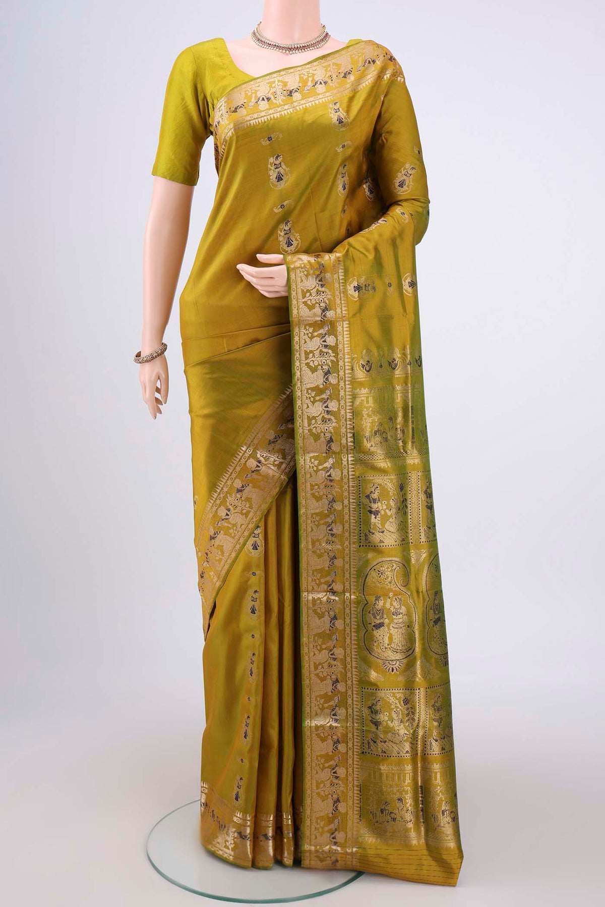 Acid Green Baluchari Silk Saree with Zari And Thread Butta on the body and Zari And Thread Border.  displayed on a mannequin