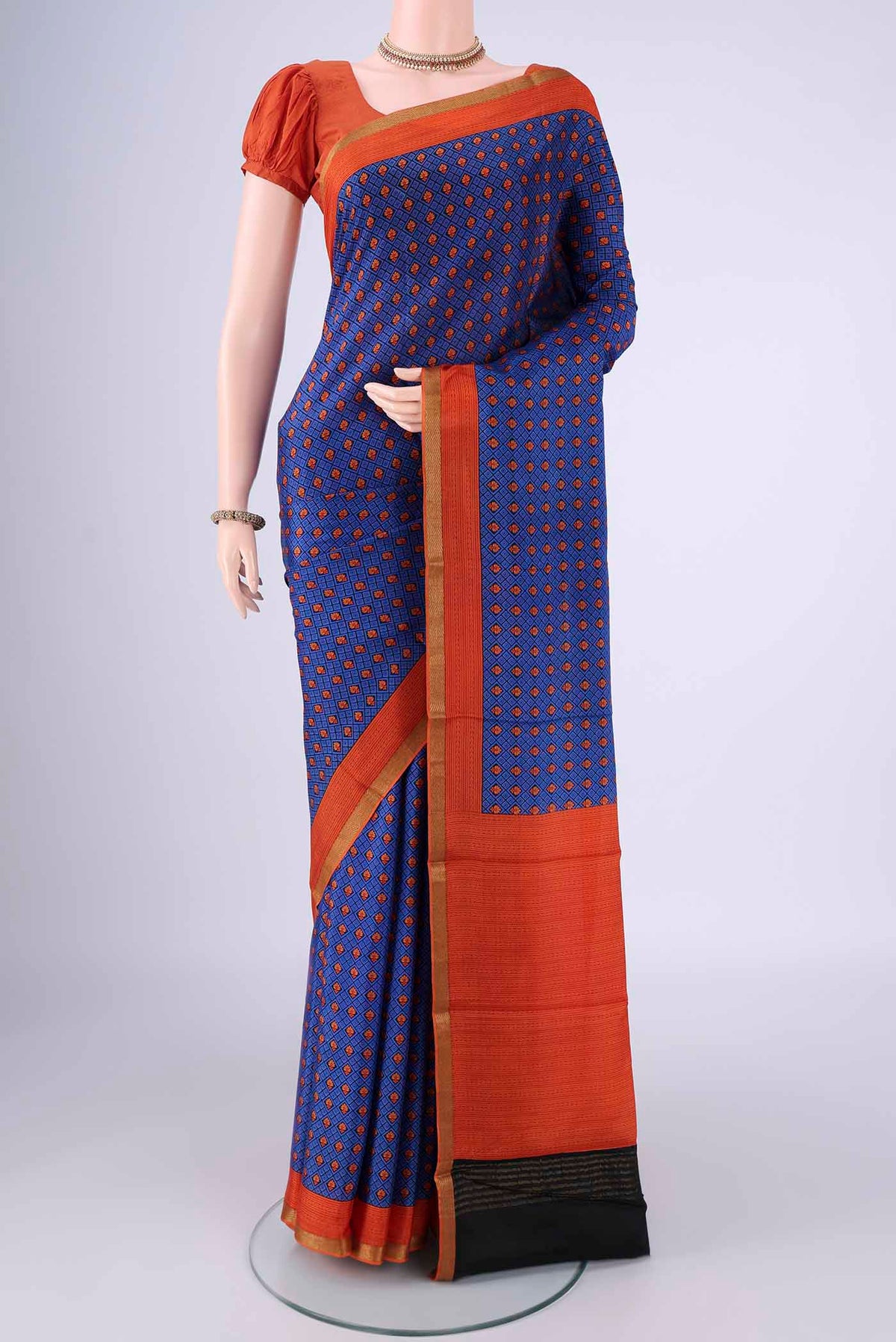 Royal Blue Mysore Crepe Saree with Printed design on the body and Printed Border.  displayed on a mannequin
