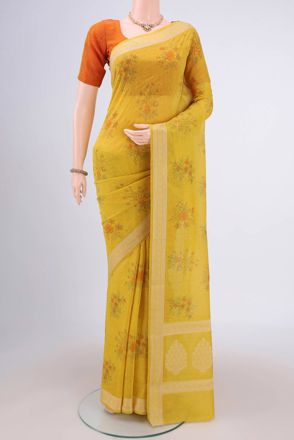 Yellow Chanderi Silk Cotton Saree with Printed design on the body and Thread Border.  displayed on a mannequin