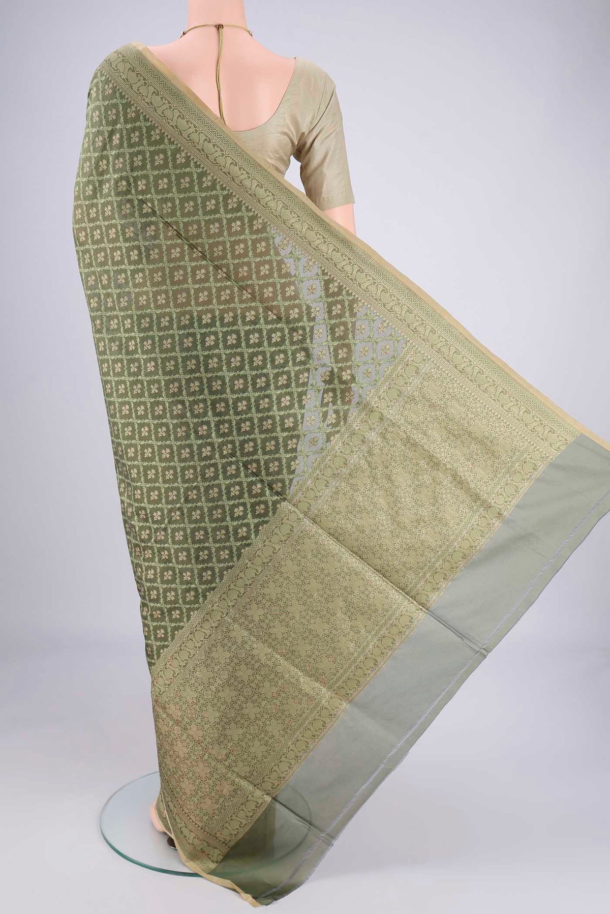 Flat view of Olive Green Banarasi Silk Saree with Jacquard With Zari Butta on the body and Zari Border. 