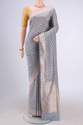 Blue Grey Banarasi Silk Saree with Stripes on the body and Zari Border.  displayed on a mannequin