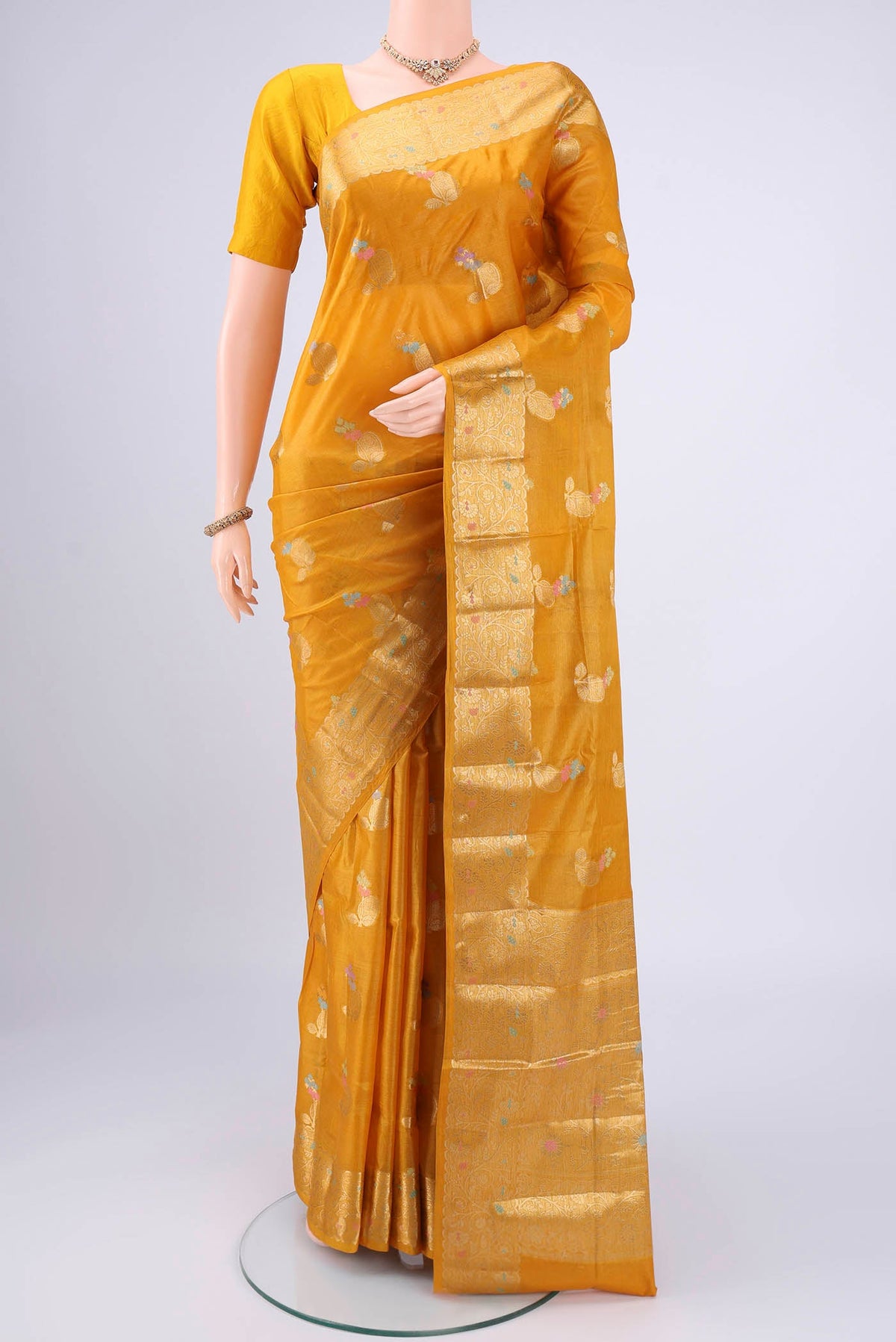Mustard Banarasi Tussar Silk Saree with Zari And Thread Butta on the body and Zari And Thread Border.  displayed on a mannequin