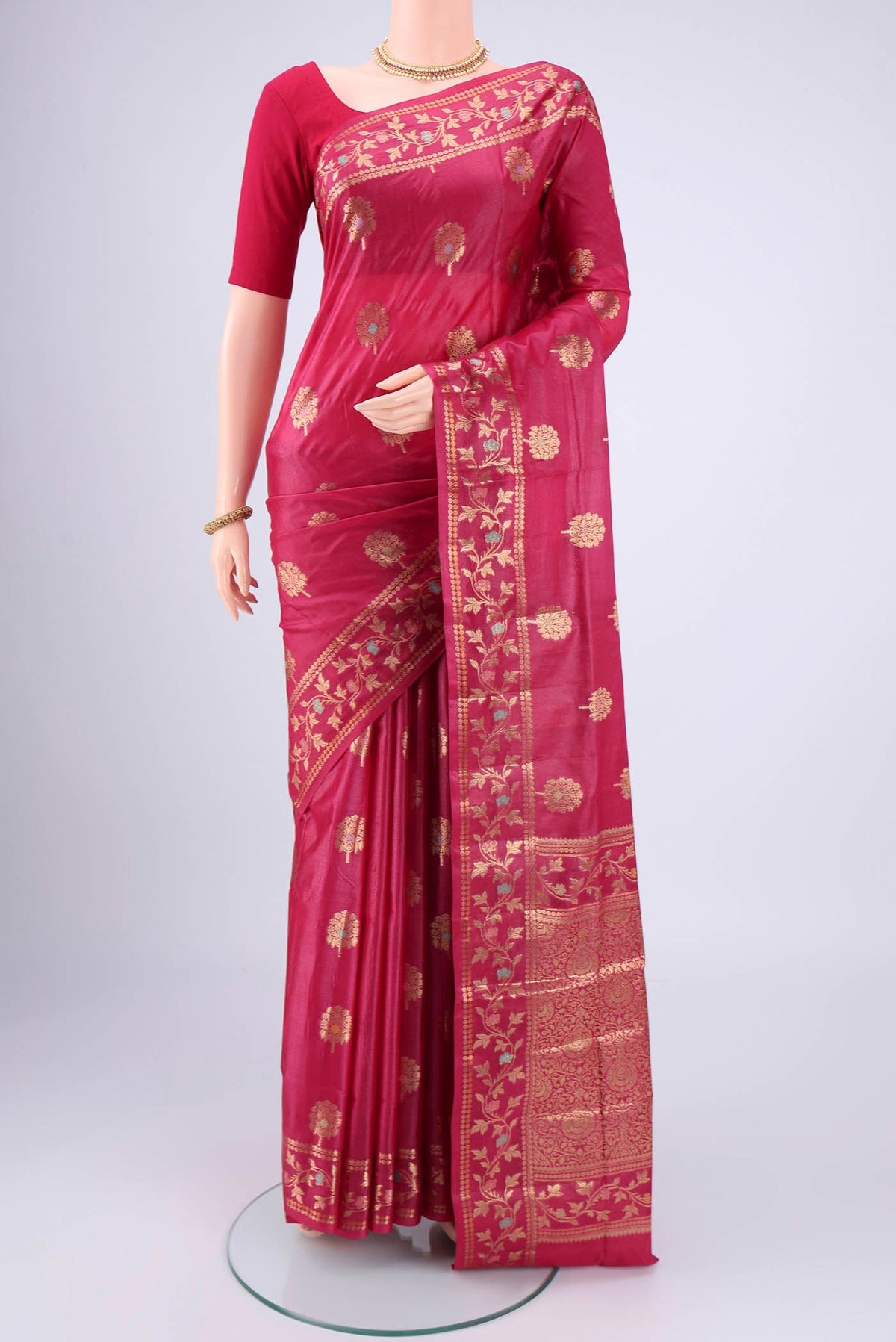Rani Pink Banarasi Tussar Silk Saree with Zari And Thread Butta on the body and Zari And Thread Border.  displayed on a mannequin