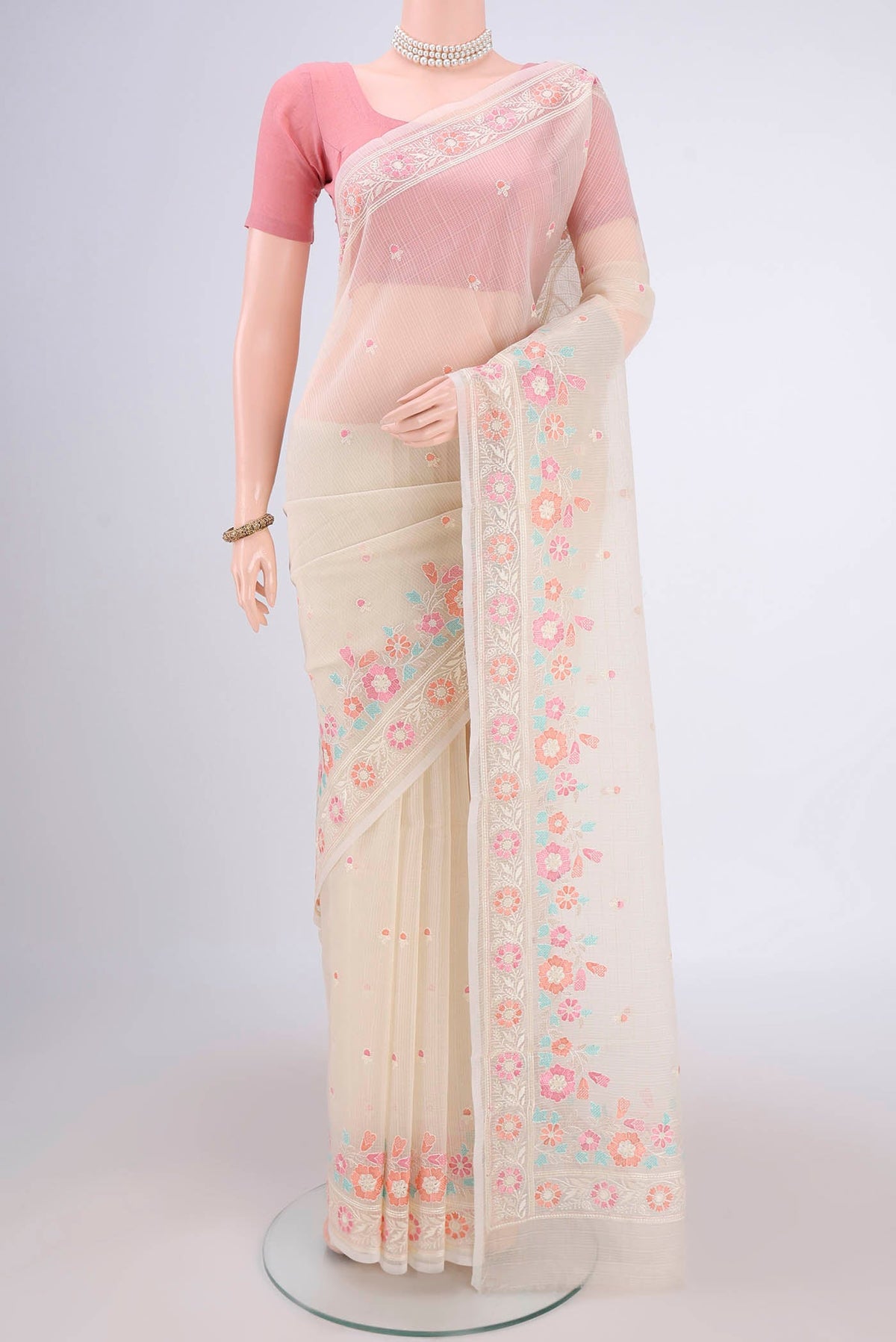 Off White Blended Kota Cotton Saree with Thread Butta on the body and Embroidery Border.  displayed on a mannequin