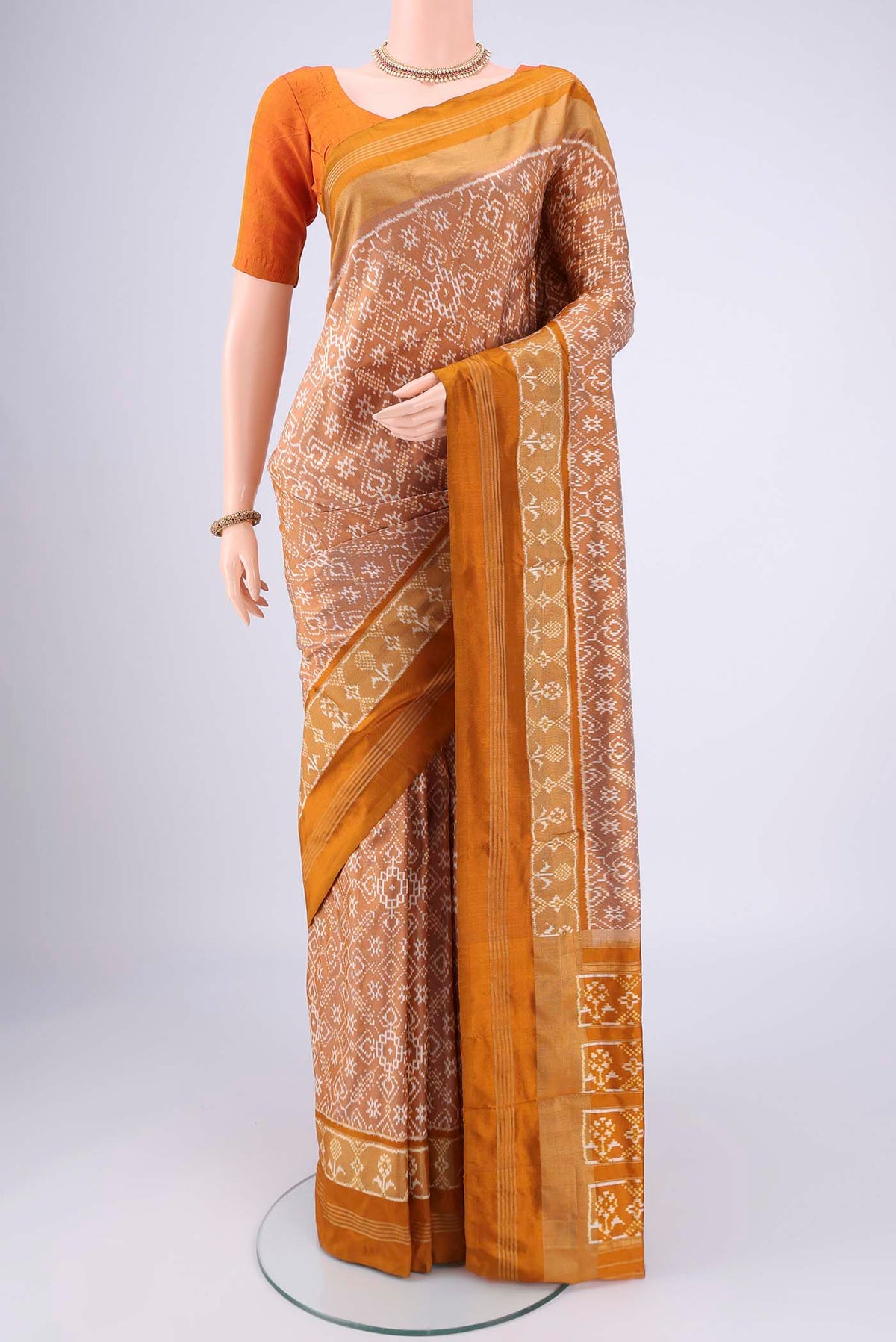 Sandal Pochampally Silk Saree with Checked design on the body and Zari Border.  displayed on a mannequin