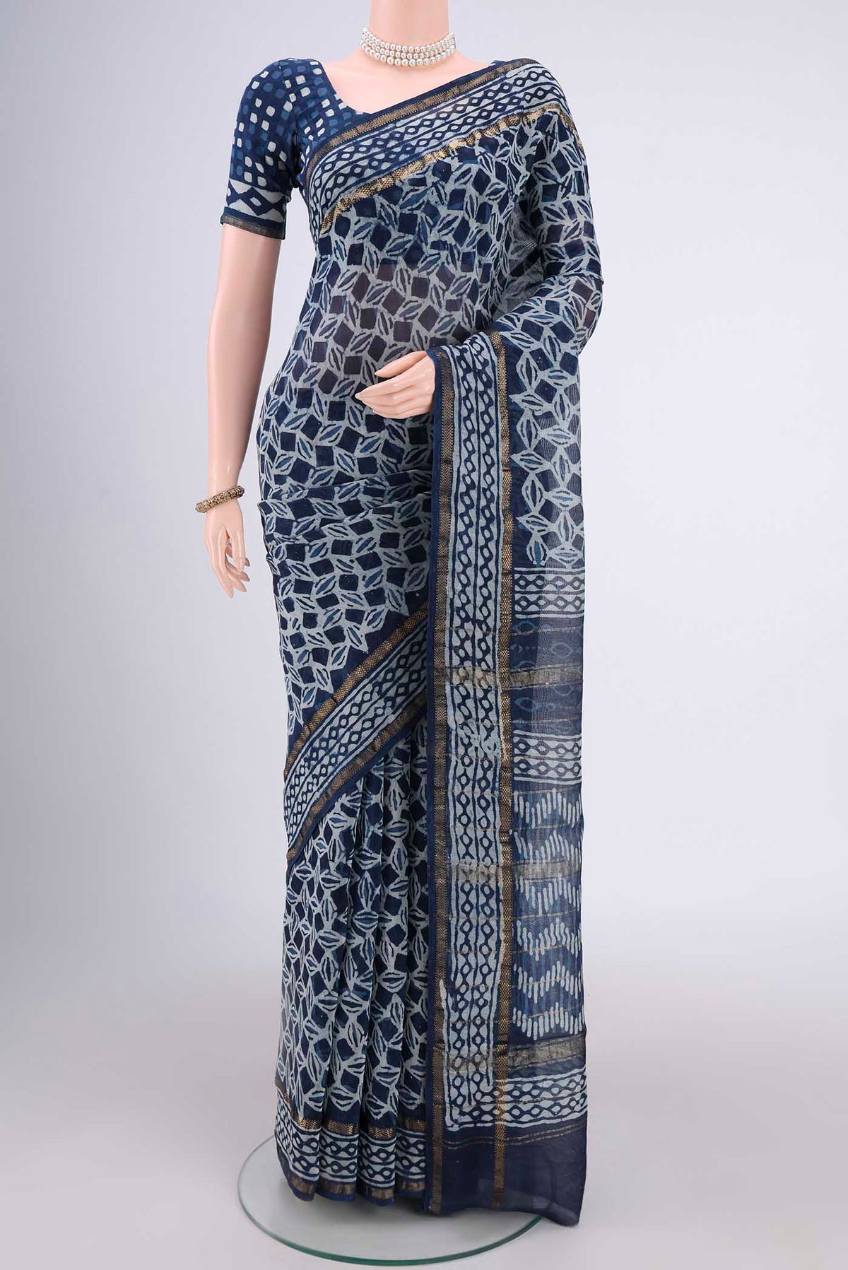 Indigo Maheshwari Silk Cotton Saree with Batik Print on the body and Zari Border.  displayed on a mannequin