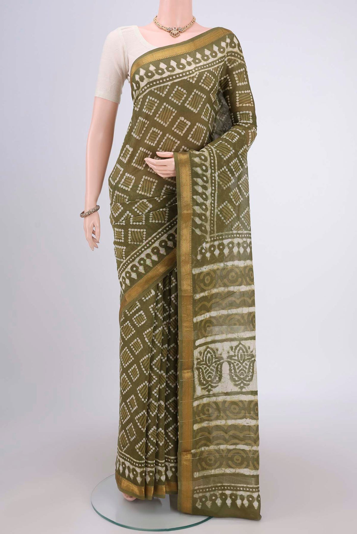 Mehandi Green Maheshwari Silk Cotton Saree with Batik Print on the body and Zari Border.  displayed on a mannequin