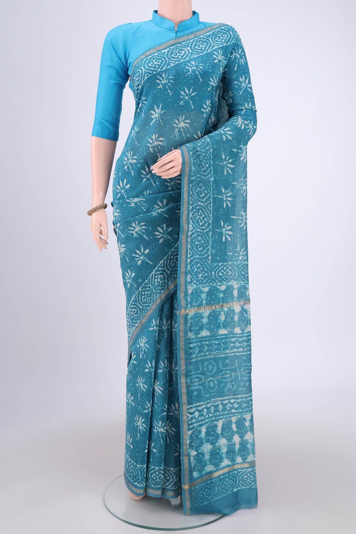 Maya Blue Chanderi Silk Saree with Batik Print on the body and Zari Border.  displayed on a mannequin
