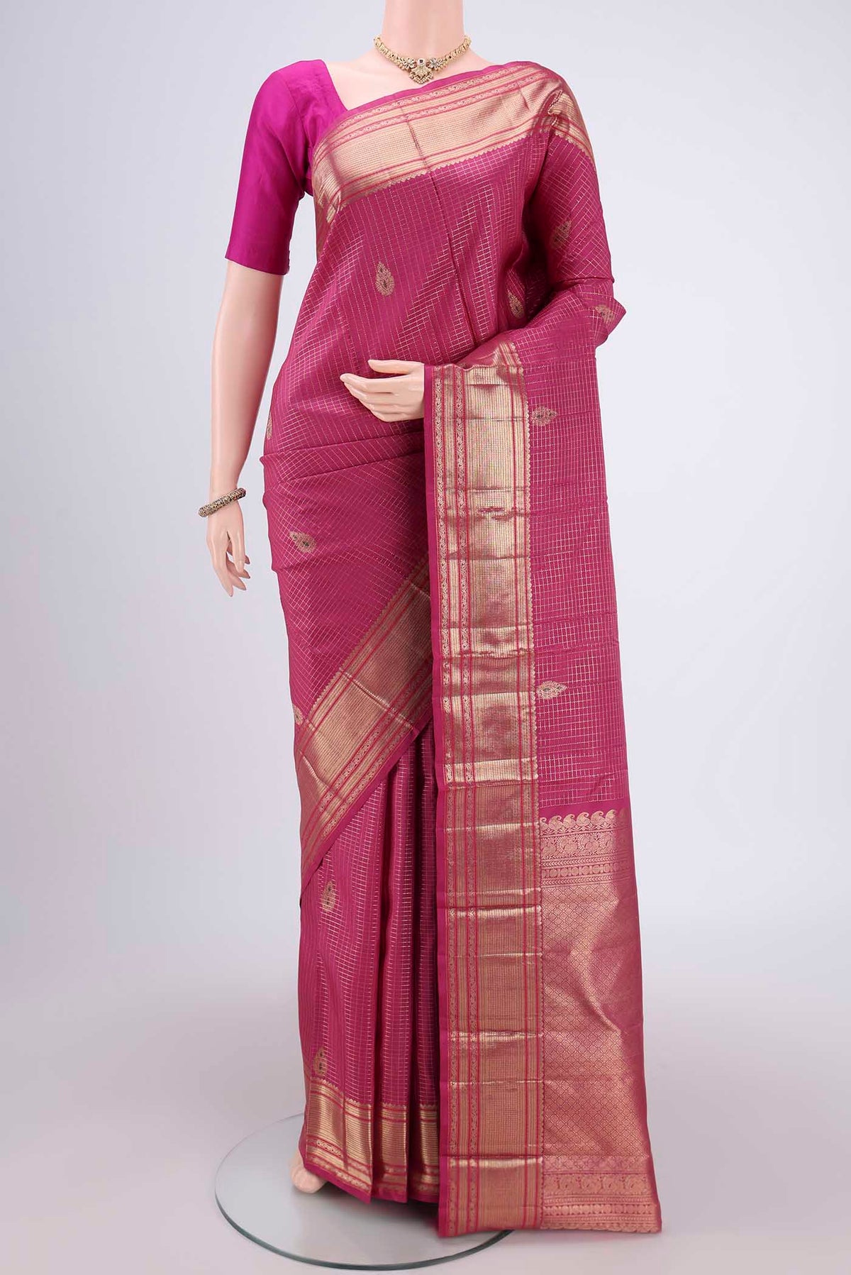 Pink Kanjivaram Silk Saree with Checked design on the body and Zari And Thread Border.  displayed on a mannequin