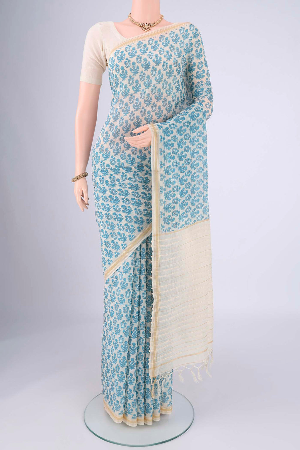 Off White Tussar Silk Saree with Floral Print on the body and Thread Border.  displayed on a mannequin