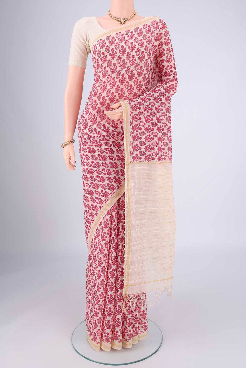 Off White Tussar Silk Saree with Floral Print on the body and Thread Border.  displayed on a mannequin