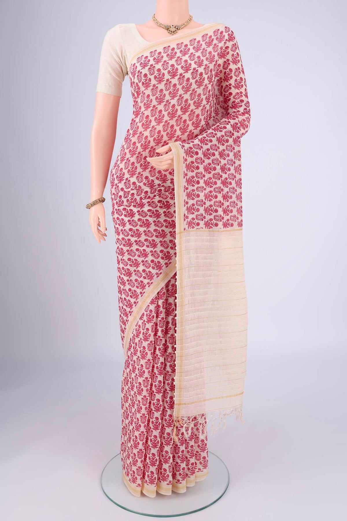 Off White Tussar Silk Saree with Floral Print on the body and Thread Border.  displayed on a mannequin