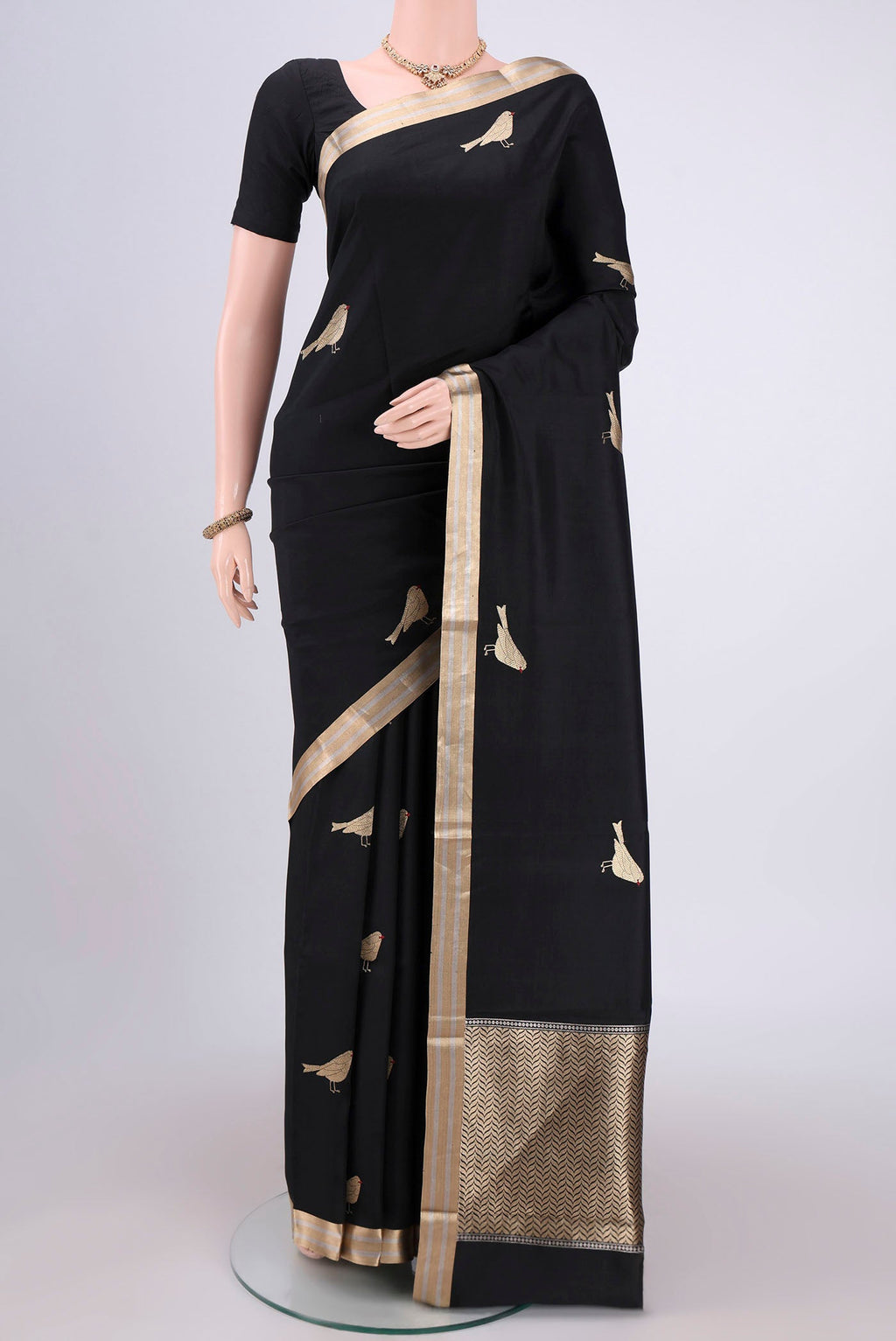 Black Banarasi Katan Silk Saree with Zari Butta on the body and Zari Border.  displayed on a mannequin