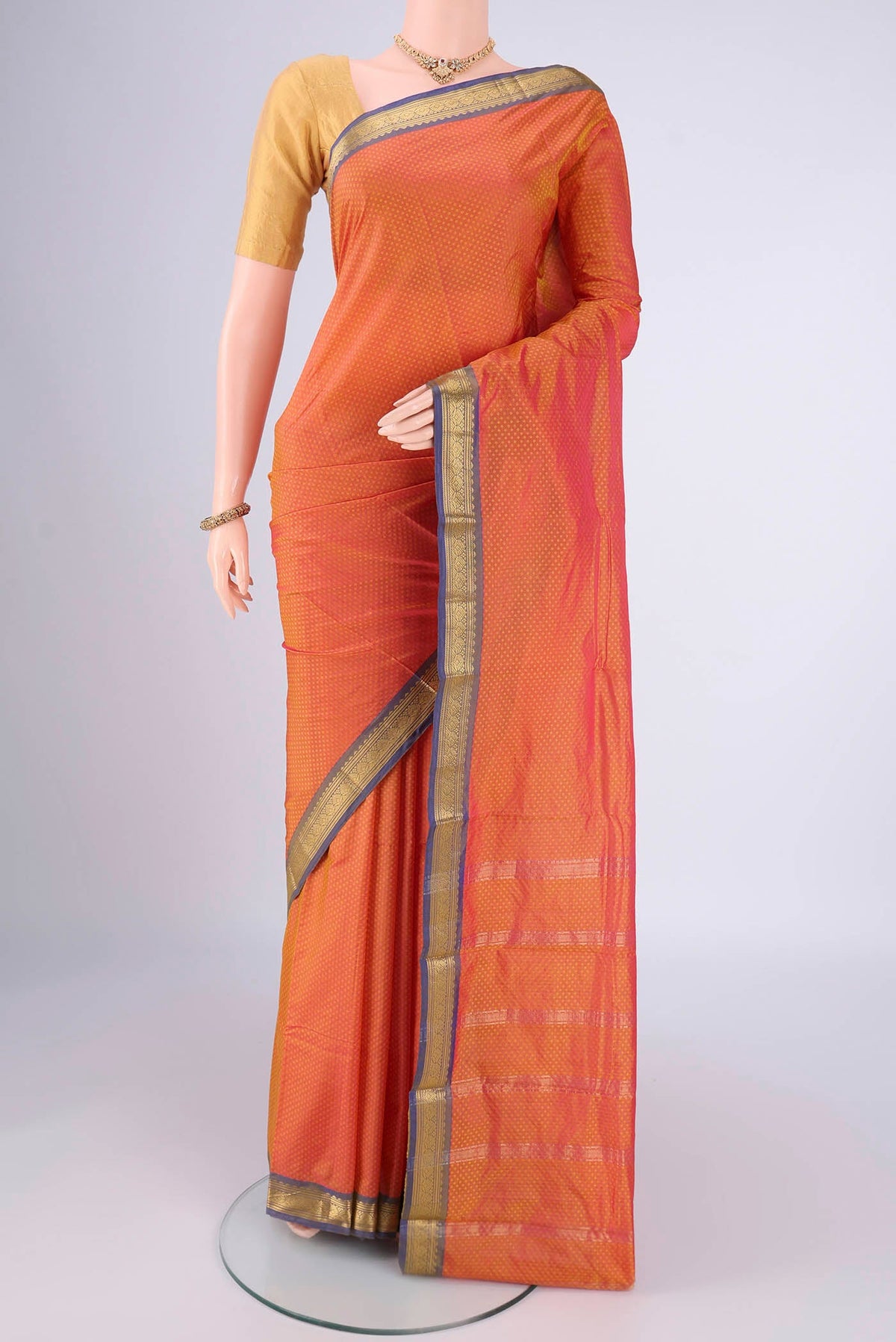 Brick Orange Blended Bangalore Silk Saree with Jacquard design on the body and Zari Border.  displayed on a mannequin
