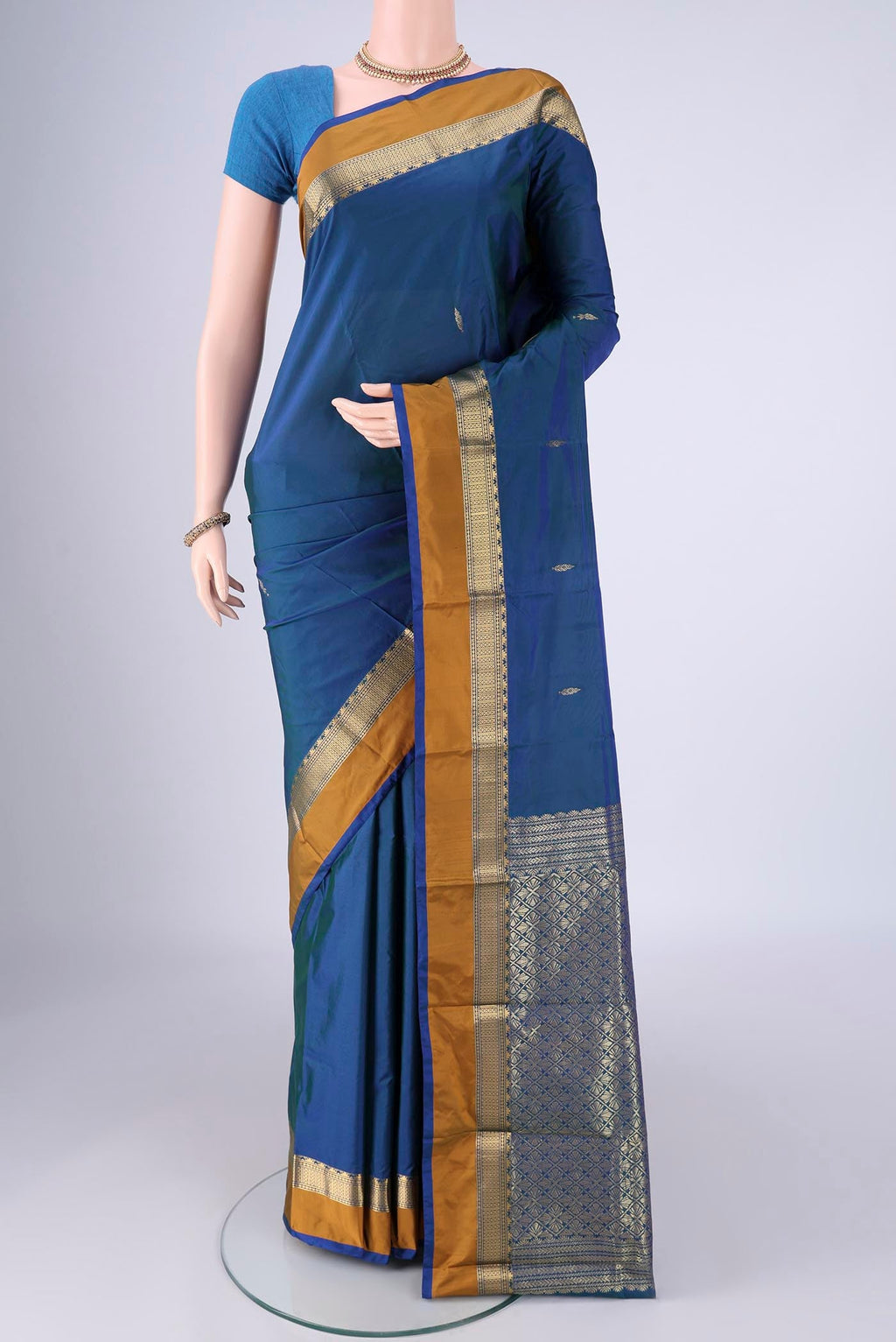 Peacock Blue Dual Tone Blended Bangalore Silk Saree with Zari Butta on the body and Zari Border.  displayed on a mannequin
