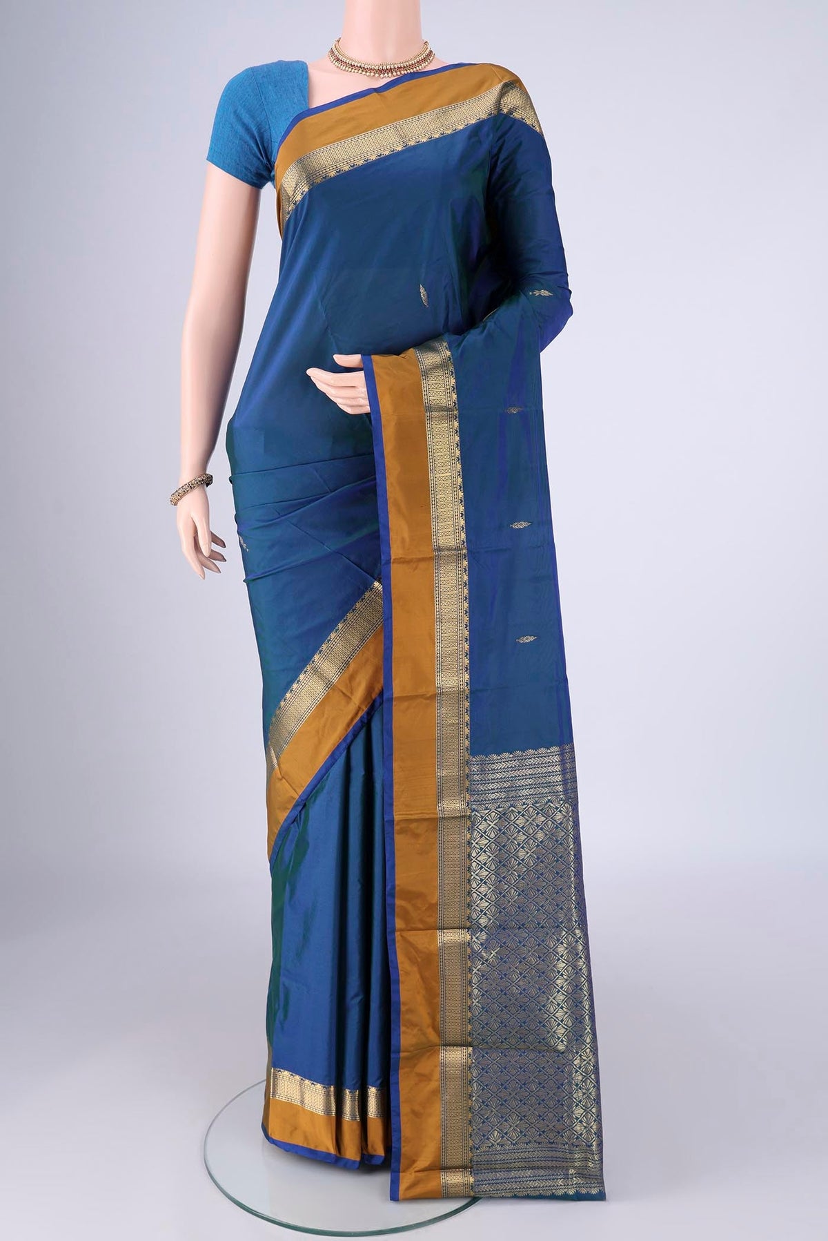 Peacock Blue Dual Tone Blended Bangalore Silk Saree with Zari Butta on the body and Zari Border.  displayed on a mannequin