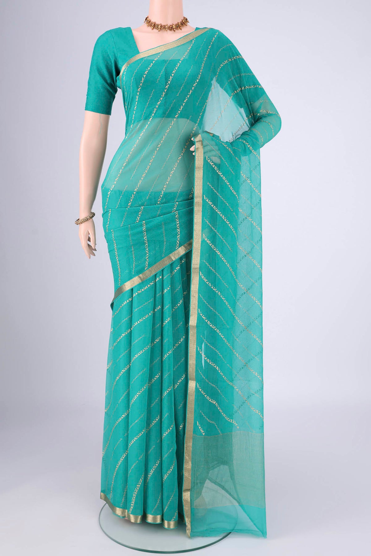 Turquoise Mysore Chiffon Saree with Stripes on the body and Zari Border.  displayed on a mannequin