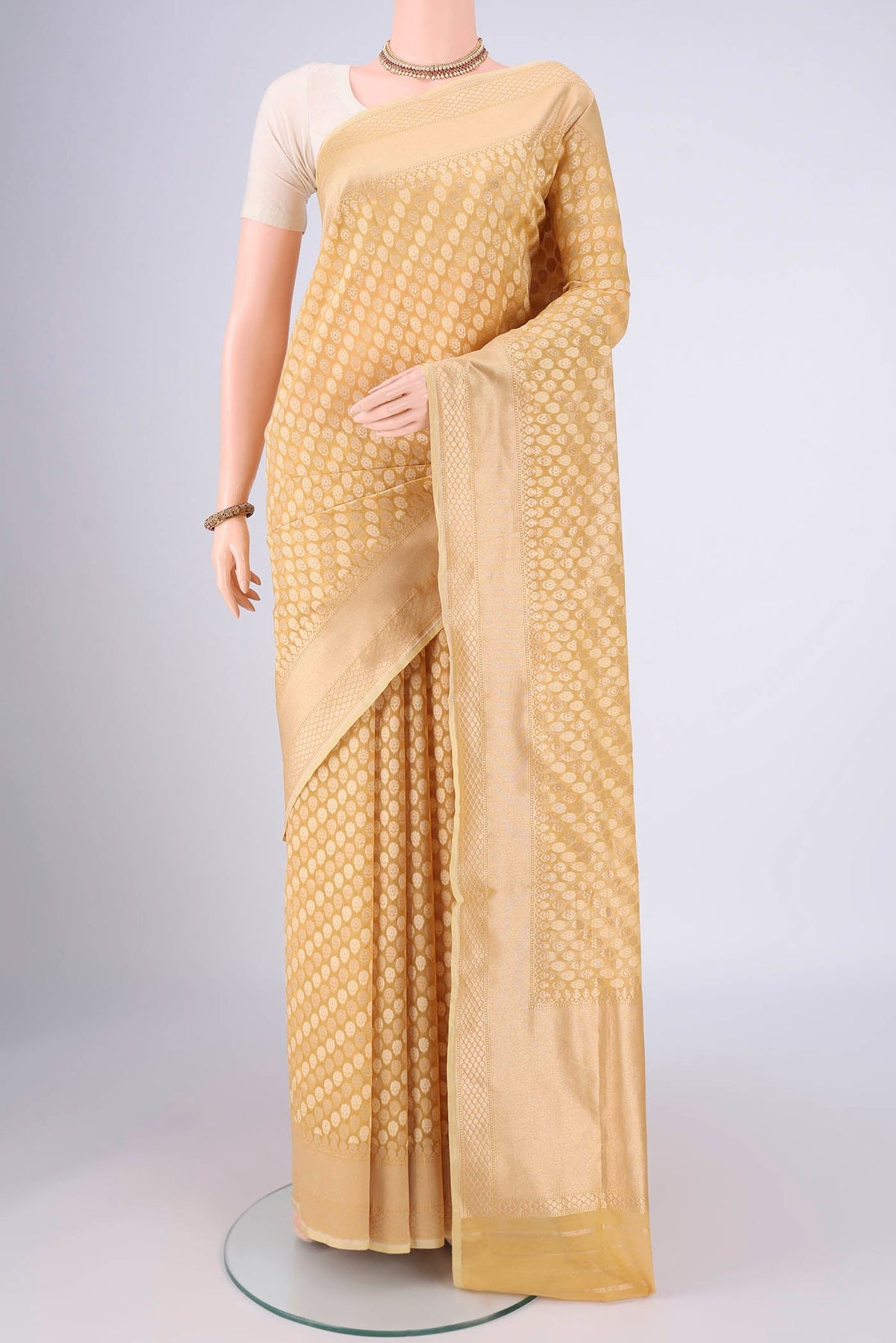 Sandal Banarasi Silk Saree with Jacquard With Zari Butta on the body and Zari Border.  displayed on a mannequin