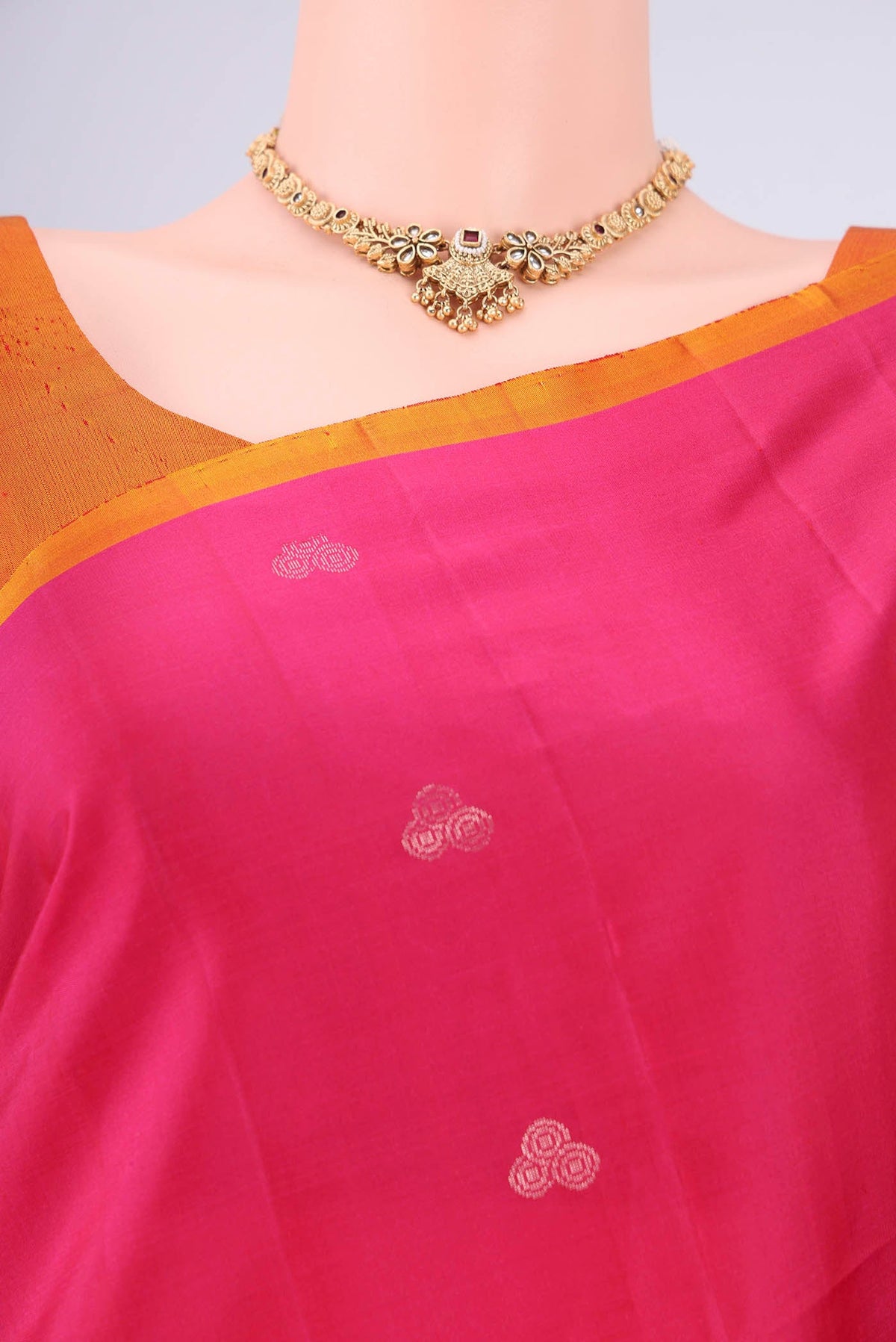 Border image of Rani Pink Soft Silk Saree with Zari Butta on the body and Plain Border. 