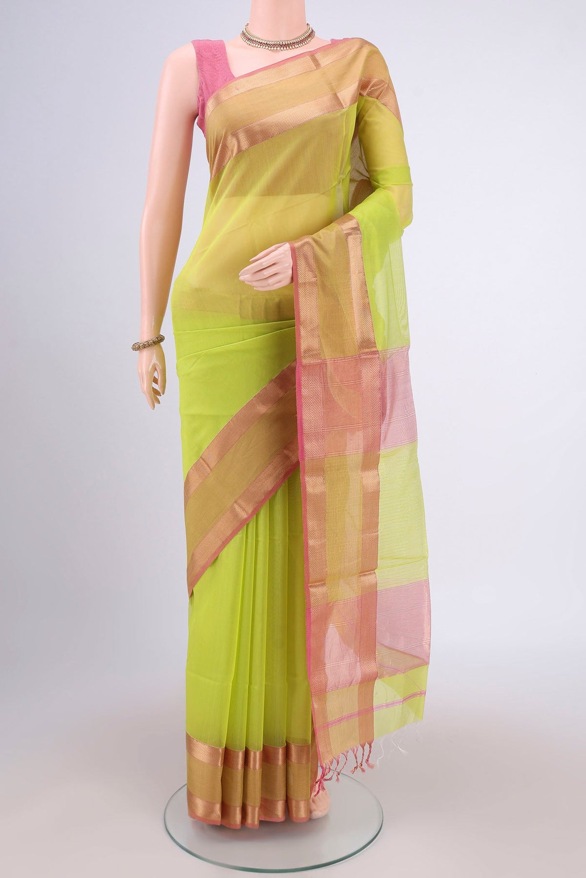 Parrot Green Maheshwari Silk Cotton Saree with Plain Body and Zari Border.  displayed on a mannequin