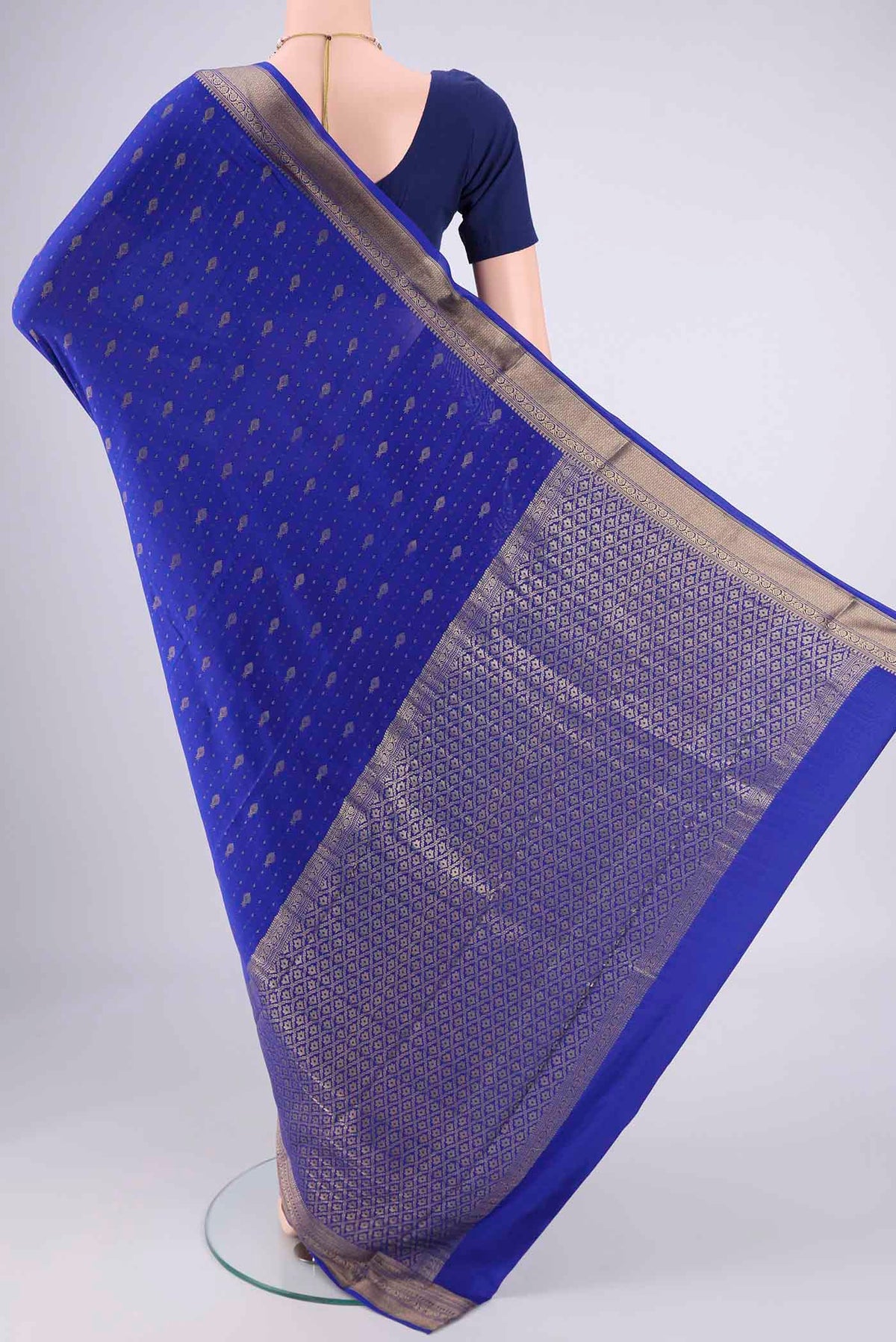 Flat view of Royal Blue Mysore Crepe Saree with Zari Butta on the body and Zari Border. 