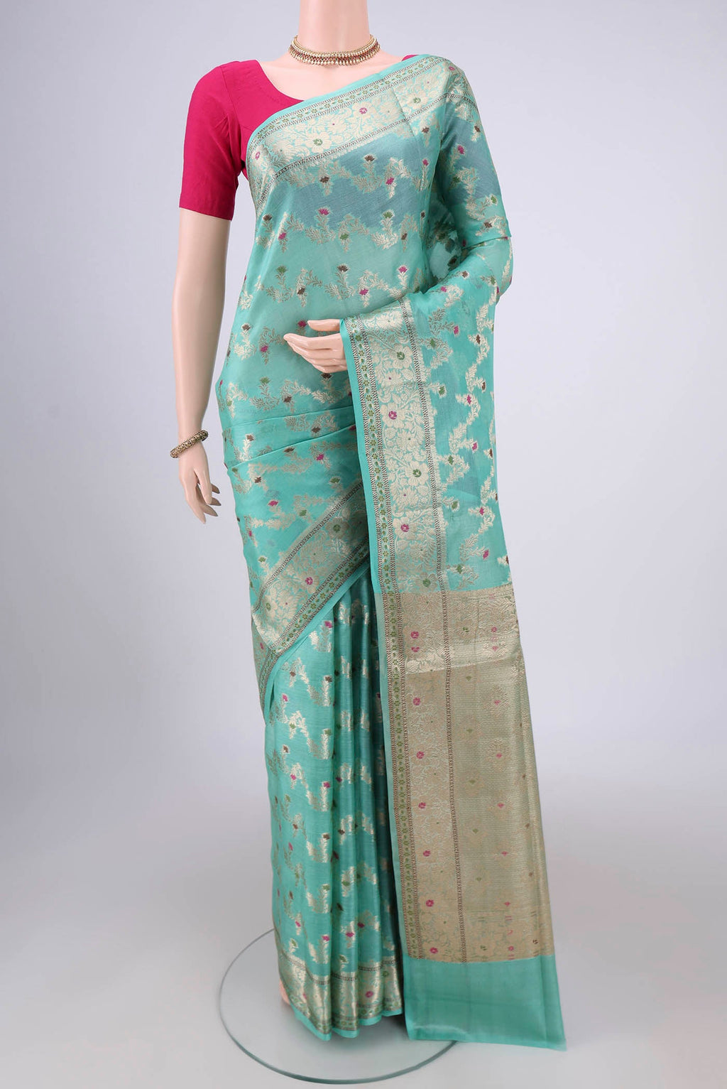 Mint Green Banarasi Tussar Silk Saree with Zari And Thread Butta on the body and Zari And Thread Border.  displayed on a mannequin