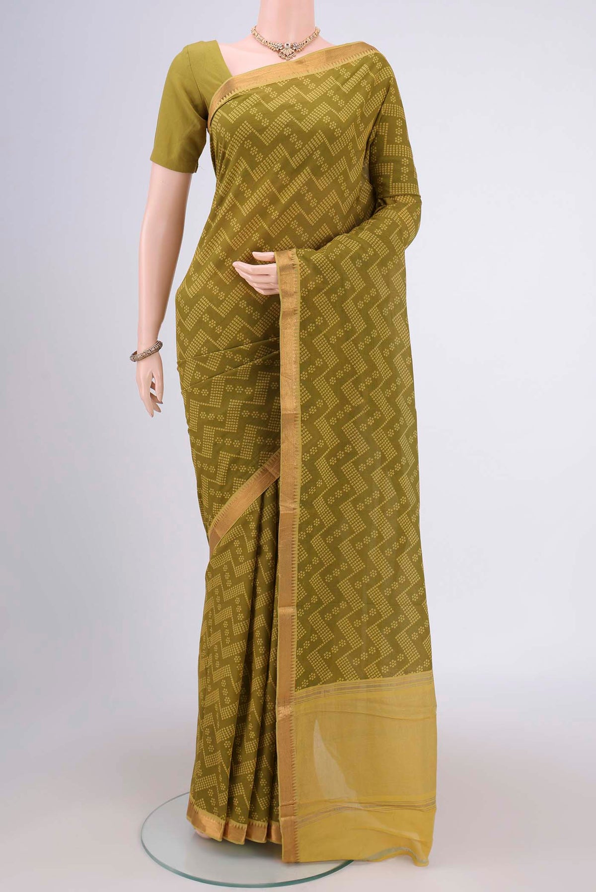 Mehandi Green Mangalagiri Cotton Saree with Printed design on the body and Zari Border.  displayed on a mannequin