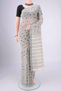 Off White Tussar Silk Saree with Printed design on the body and Plain Border.  displayed on a mannequin