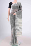 Off White Tussar Silk Saree with Printed design on the body and Plain Border.  displayed on a mannequin