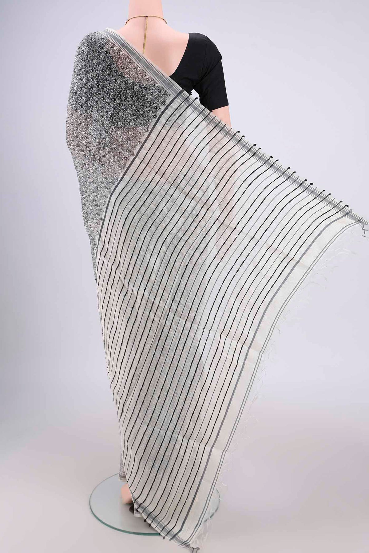 Flat view of Off White Tussar Silk Saree with Printed design on the body and Plain Border. 