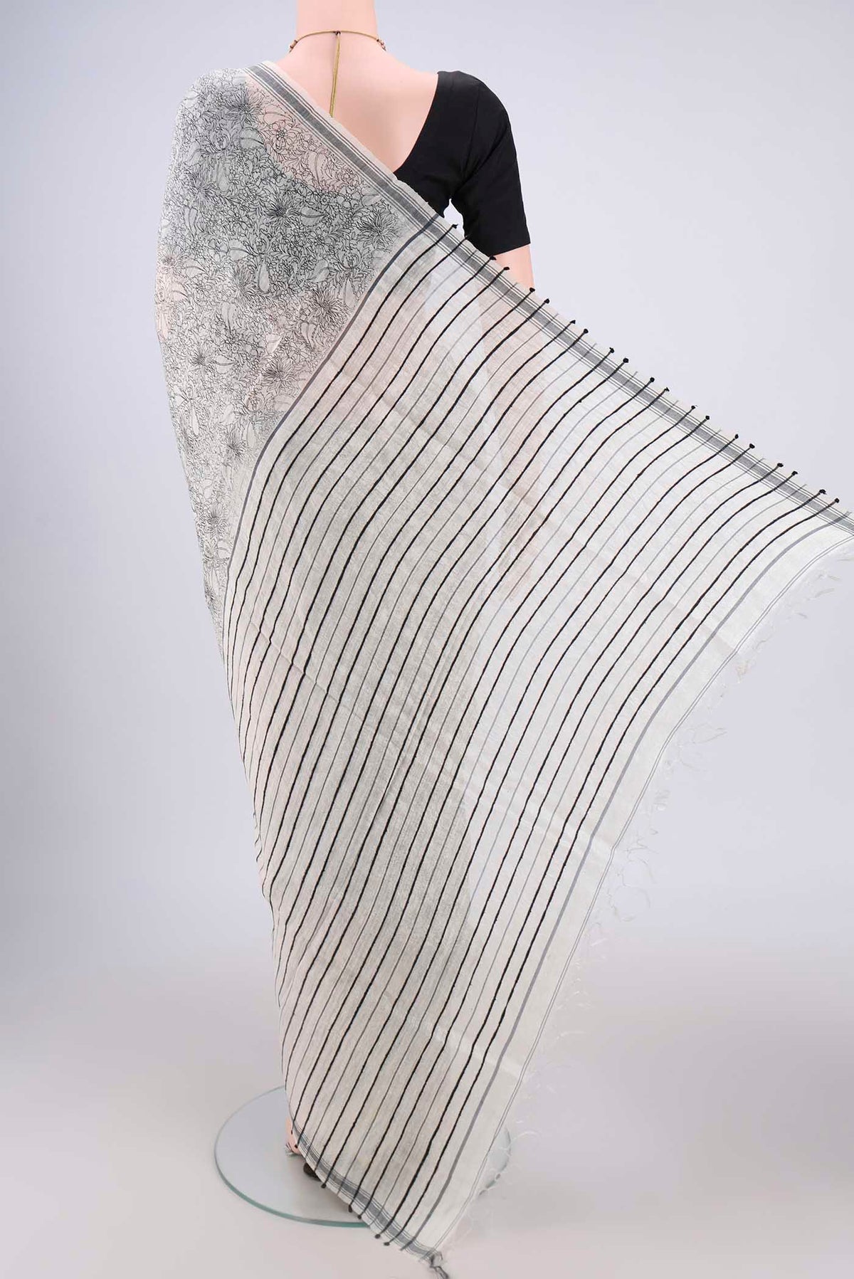 Flat view of Off White Tussar Silk Saree with Printed design on the body and Plain Border. 