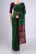 Bottle Green Silk Cotton Saree with Zari Brocade on the body and Zari Border.  displayed on a mannequin