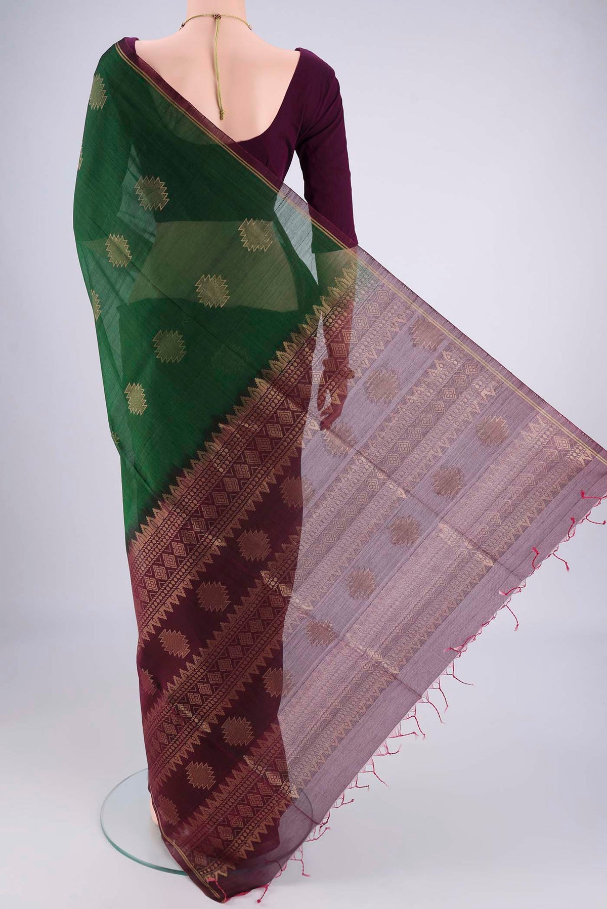 Flat view of Bottle Green Silk Cotton Saree with Zari Brocade on the body and Zari Border. 