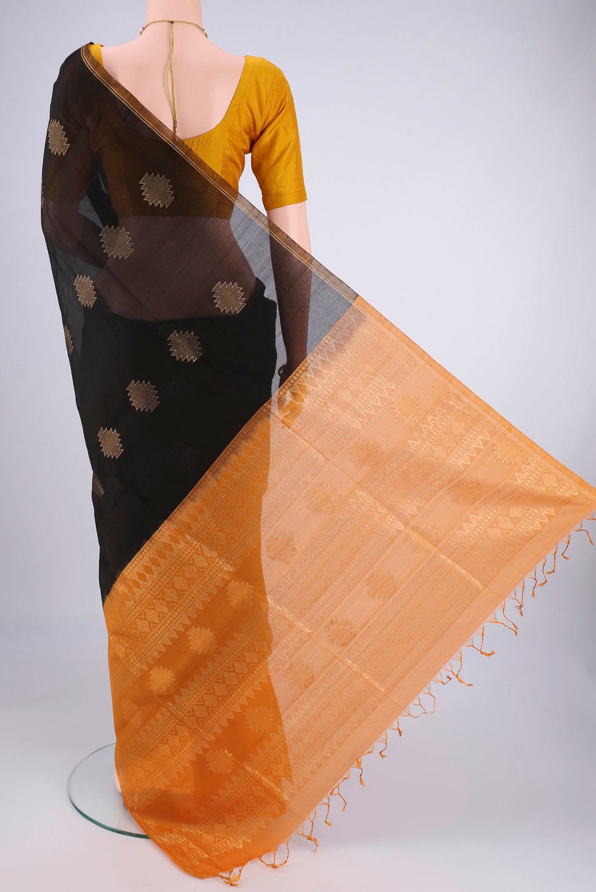 Flat view of Black Silk Cotton Saree with Zari Butta on the body and Zari Border. 