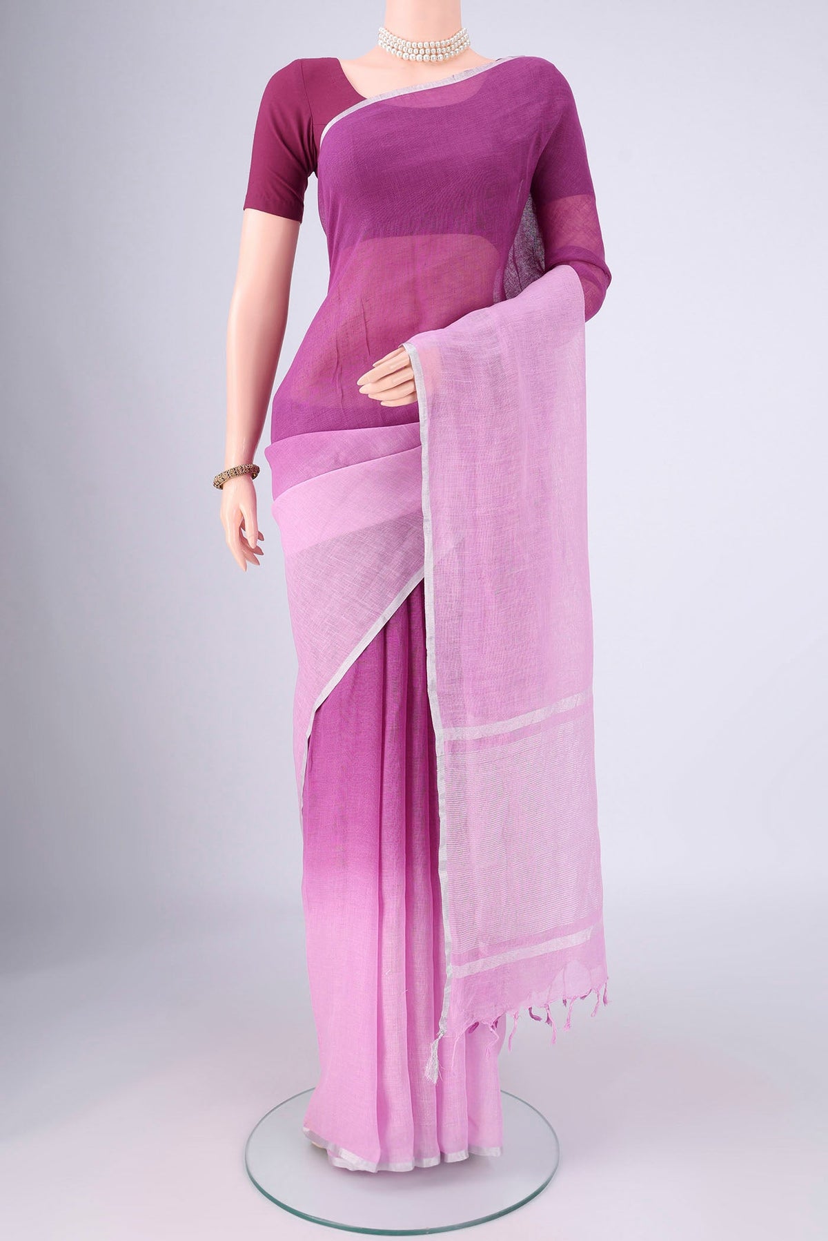 Mauve Linen Saree with Half And Half on the body and Thin Zari Line.  displayed on a mannequin