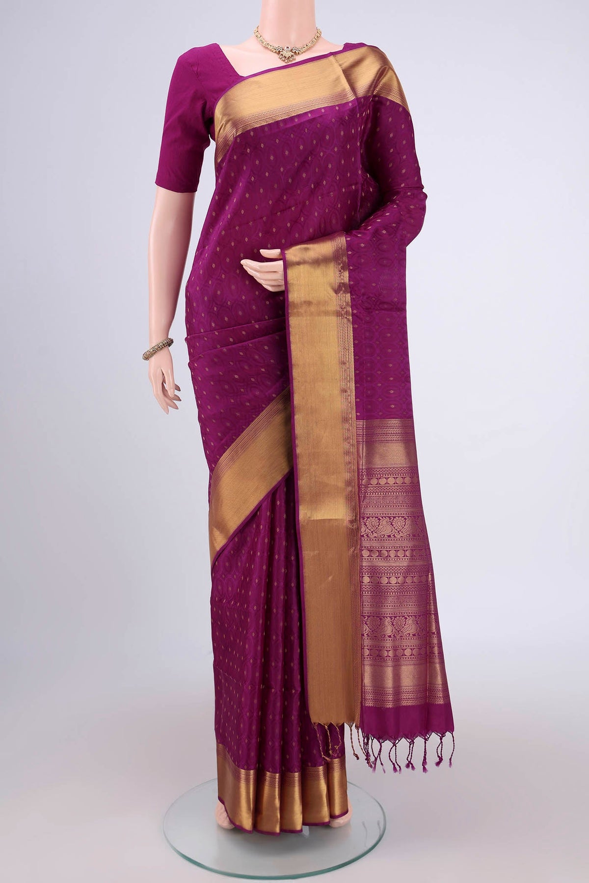 Magenta Baluchari Silk Saree with Jacquard With Zari Butta on the body and Zari Border.  displayed on a mannequin