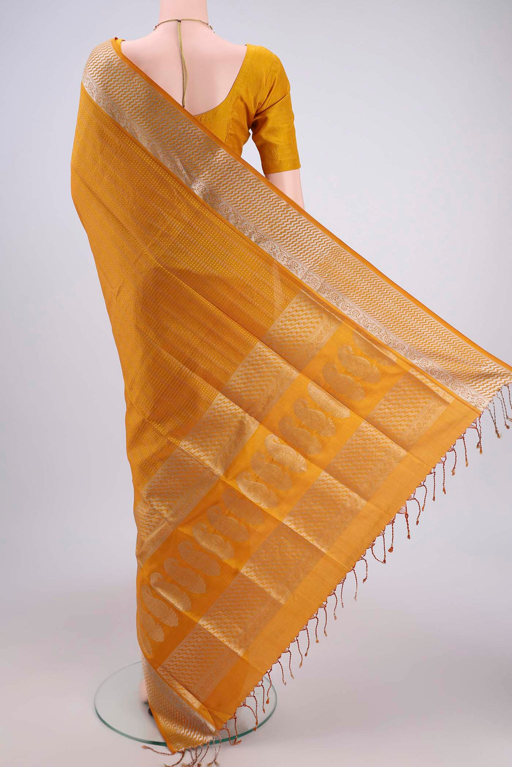 Flat view of Mustard Soft Silk Saree with Jacquard design on the body and Zari Border. 