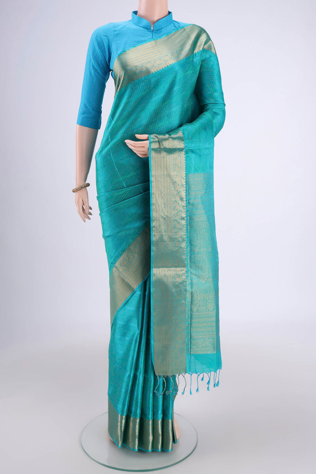 Turquoise Soft Silk Saree with Jacquard With Zari Butta on the body and Zari Border.  displayed on a mannequin