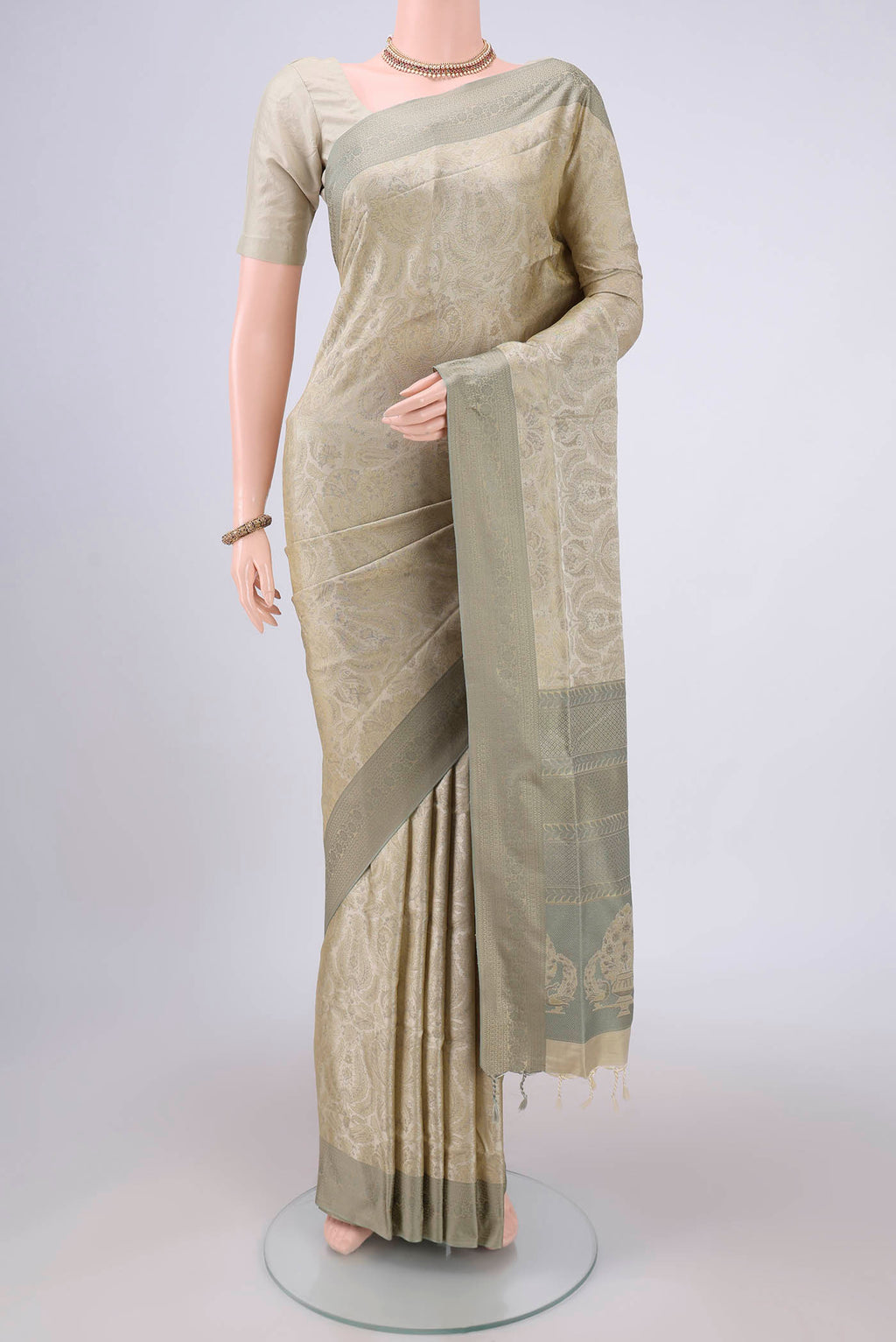 Beige Soft Silk Saree with Jacquard design on the body and Thread Border.  displayed on a mannequin