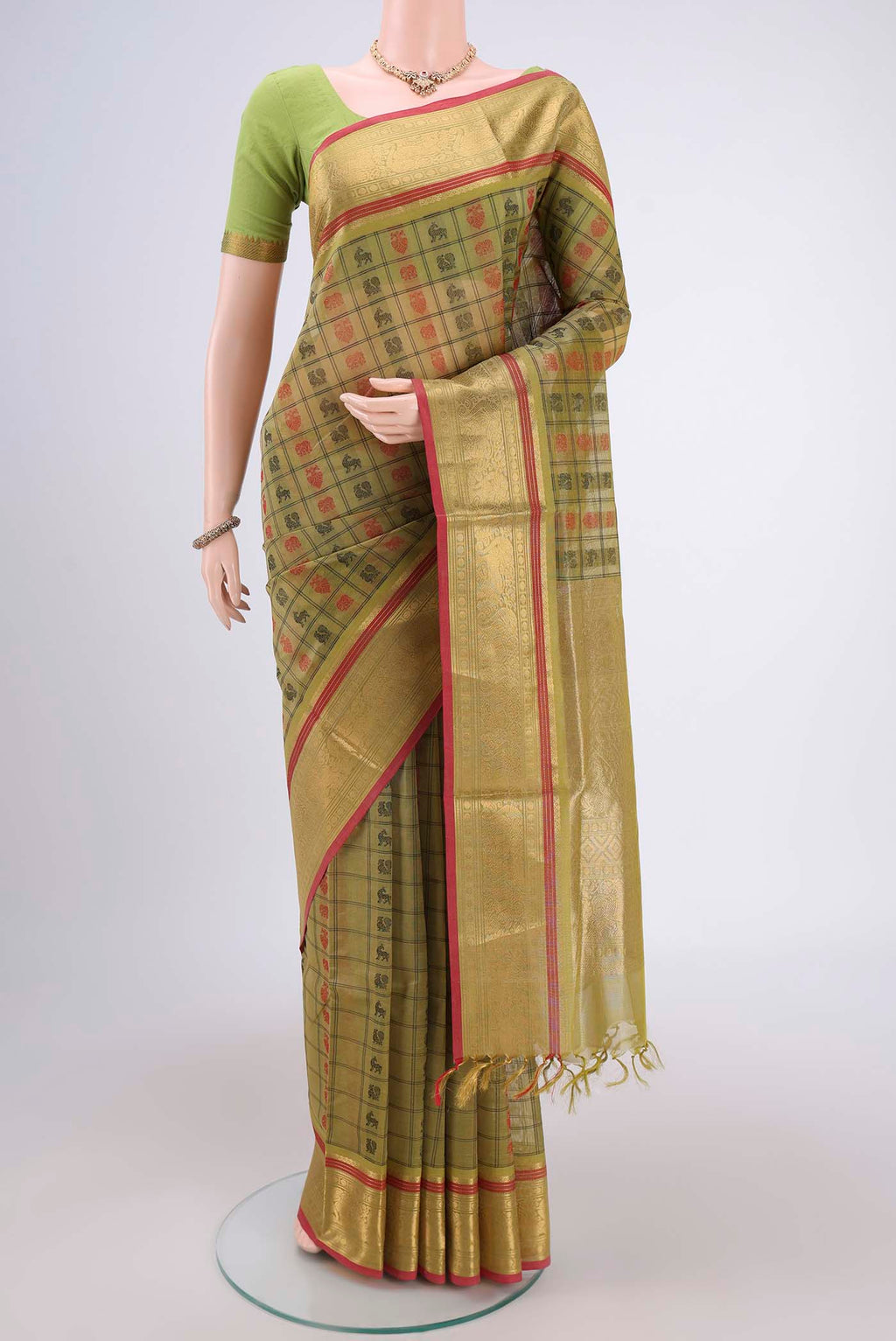 Light Green Silk Cotton Saree with Checked design on the body and Zari Border.  displayed on a mannequin