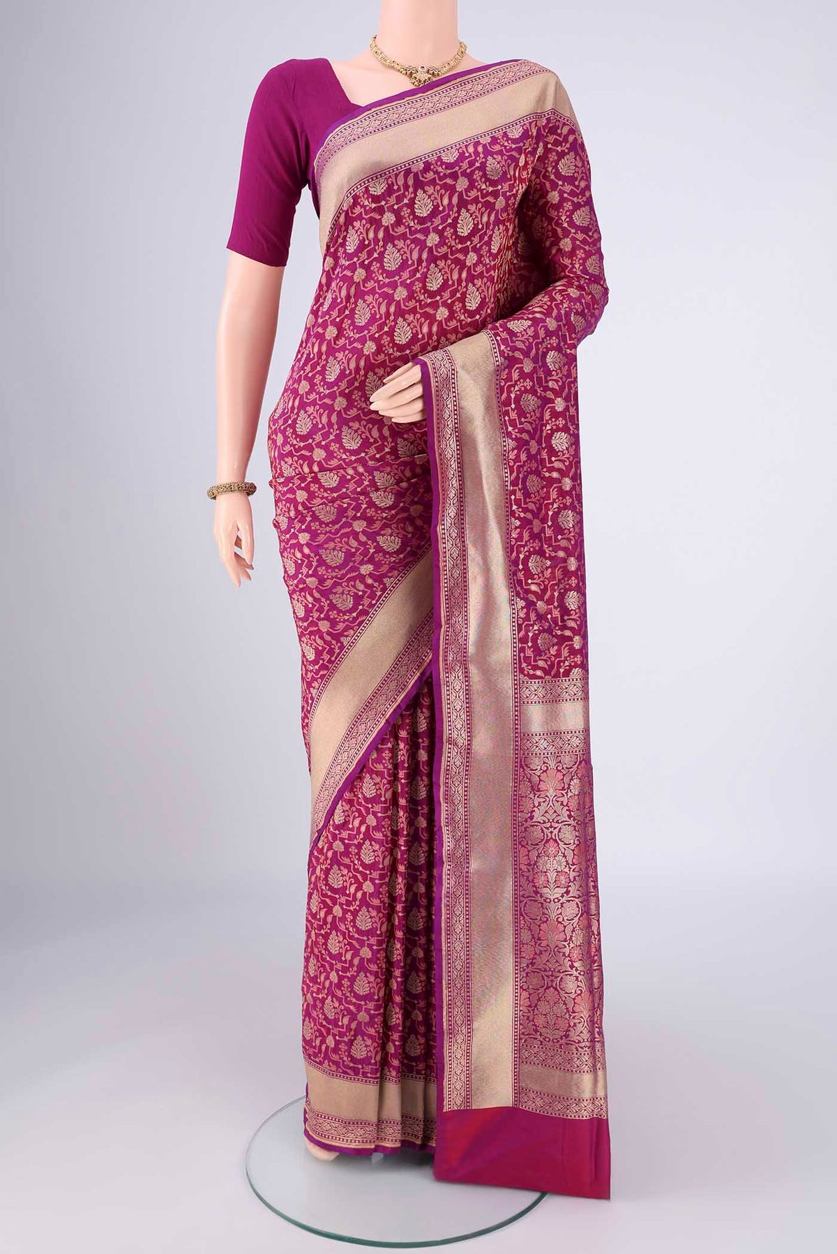Magenta Banarasi Silk Saree with Jacquard With Zari Butta on the body and Zari Border.  displayed on a mannequin