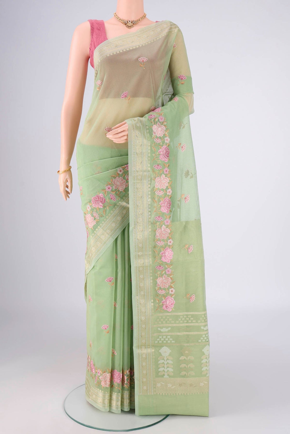Light Green Blended Kota Cotton Saree with Embroidery on the body and Zari Border.  displayed on a mannequin
