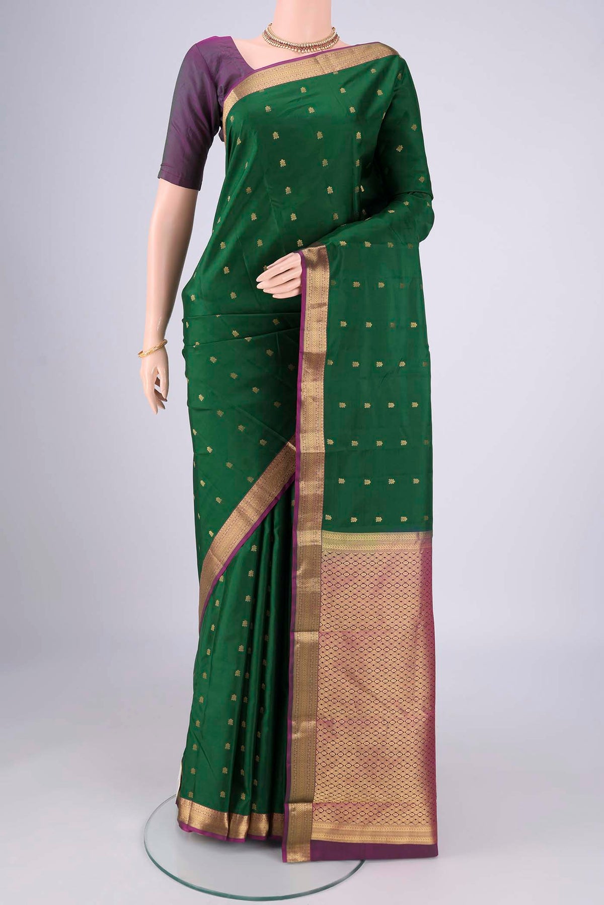 Purple Kanjivaram Silk Saree with Zari Butta on the body and Zari Border.  displayed on a mannequin