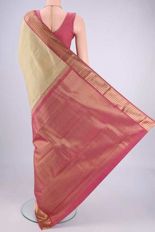 Flat view of Beige Kanchipuram Silk Saree with Zari Butta on the body and Zari Border. 