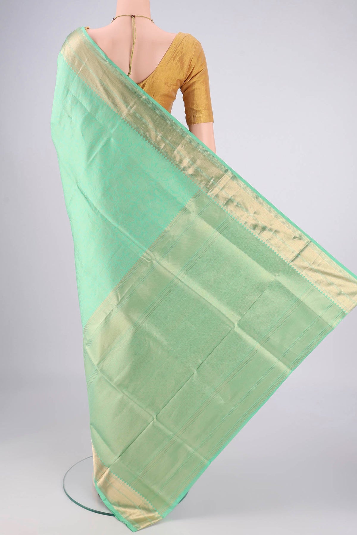 Flat view of Mint Green Soft Silk Saree with Zari Brocade on the body and Zari Border. 
