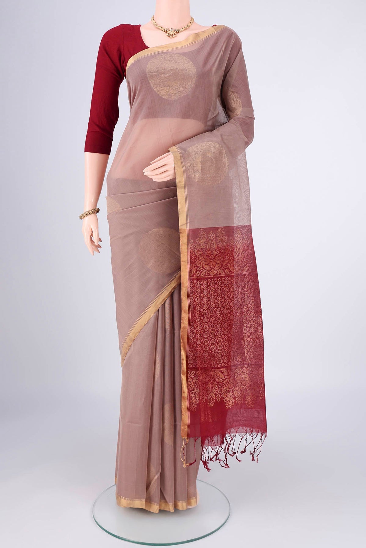 Dark Beige Kora Cotton Saree with Zari Butta on the body and Plain Border.  displayed on a mannequin